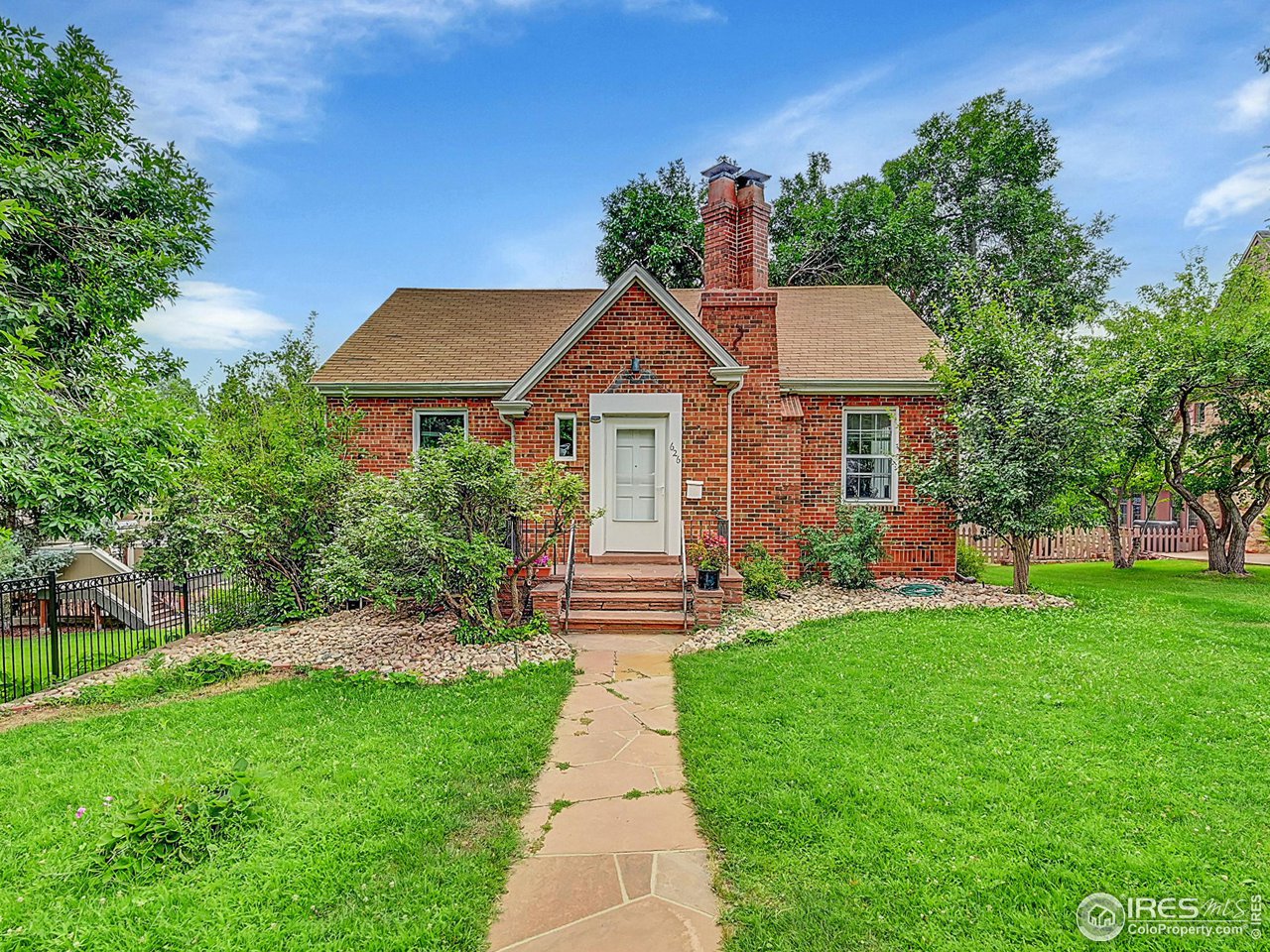 626 14th Street Boulder, CO 80302 - Photo 1 of 32 a front view of a house with a garden and yard