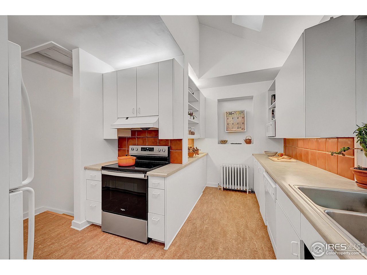 626 14th Street Boulder, CO 80302 - Photo 12 of 32 a kitchen with stainless steel appliances a stove a sink and a refrigerator