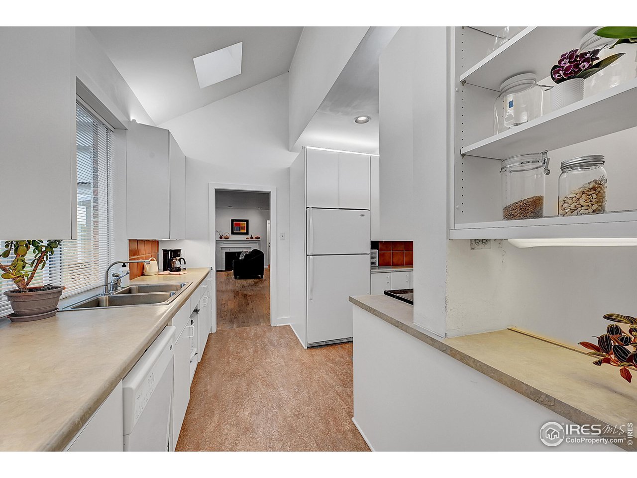 626 14th Street Boulder, CO 80302 - Photo 13 of 32 a kitchen view with cabinets microwave and stove