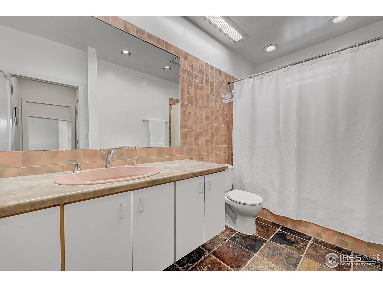 626 14th Street Boulder, CO 80302 - Photo 16 of 32 a bathroom with a sink a toilet and a mirror