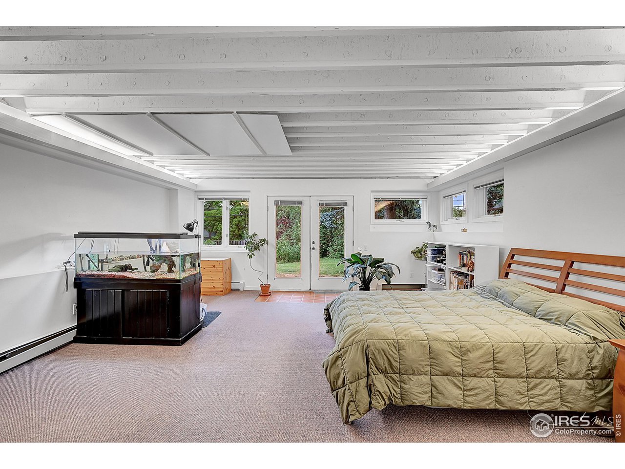 626 14th Street Boulder, CO 80302 - Photo 23 of 32 a spacious bedroom with a bed and a dresser