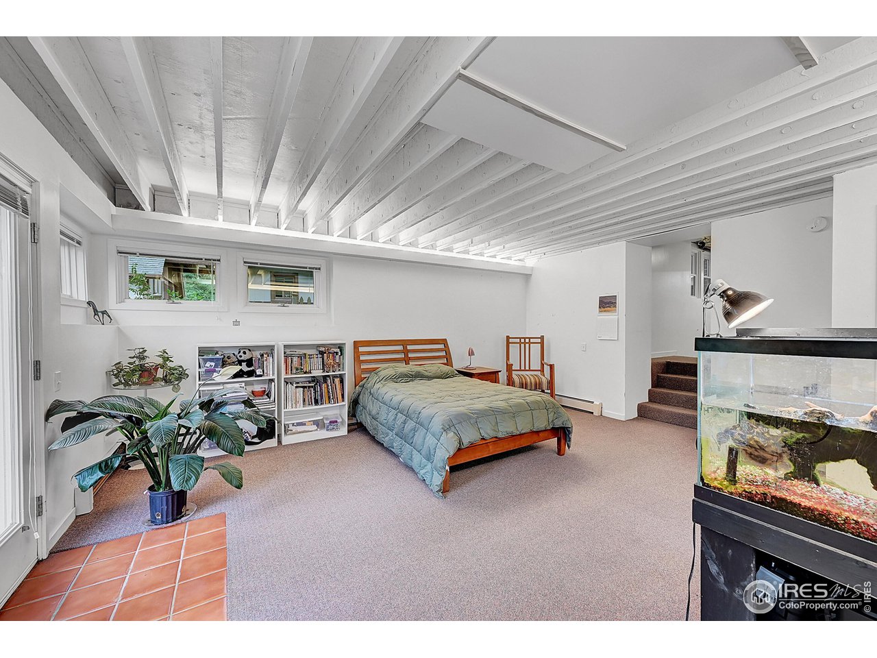 626 14th Street Boulder, CO 80302 - Photo 25 of 32 a spacious bedroom with a bed table flowerpot and a window