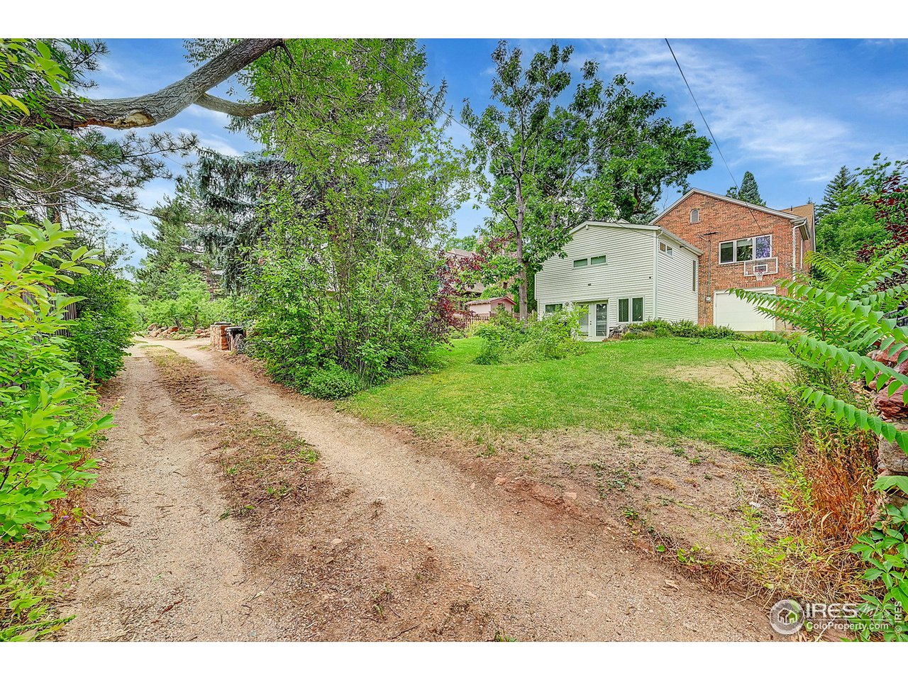 626 14th Street Boulder, CO 80302 - Photo 29 of 32 a front view of a house with a yard and garage