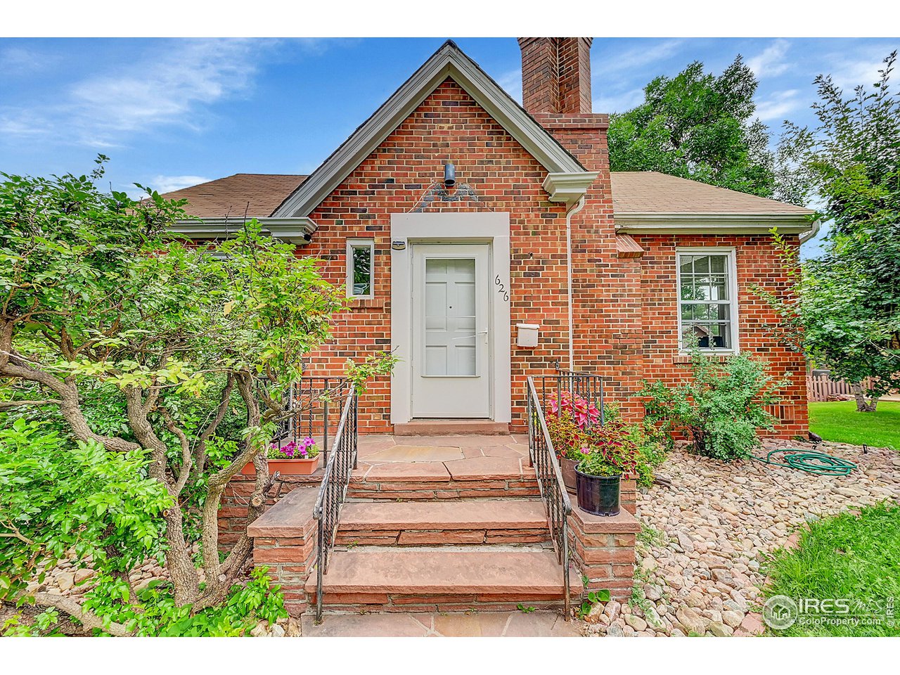 626 14th Street Boulder, CO 80302 - Photo 3 of 32 a front view of a house with a yard