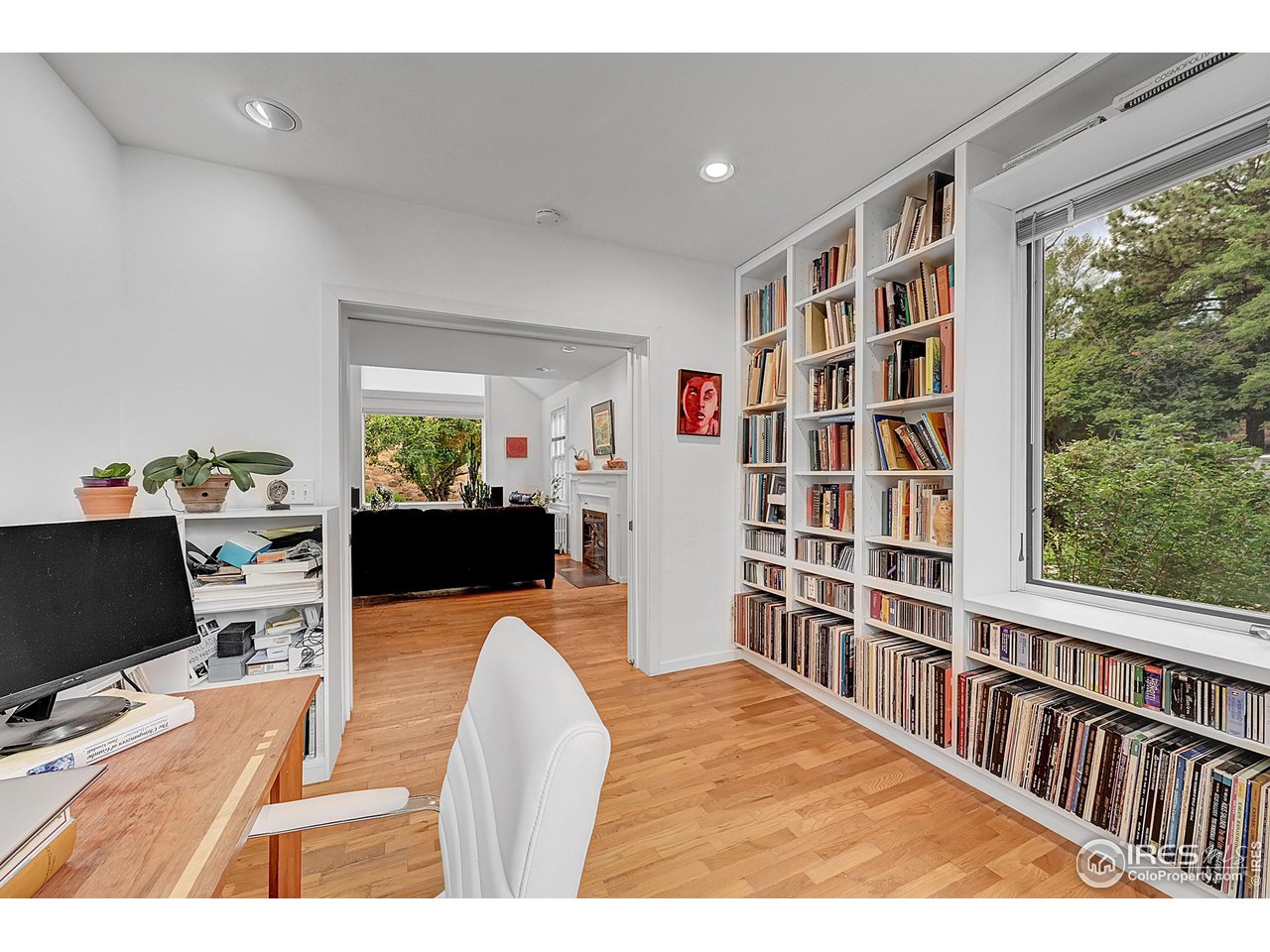 626 14th Street Boulder, CO 80302 - Photo 5 of 32 a living room with furniture a bookshelf and a wooden floor