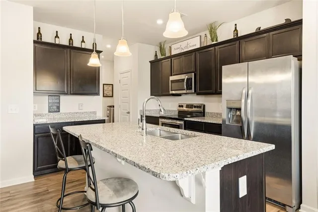 a kitchen with kitchen island a counter space and stainless steel appliances