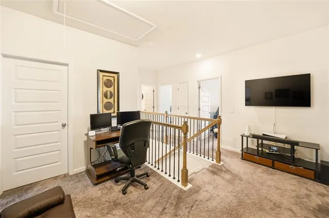 a view of a livingroom with furniture and a flat screen tv