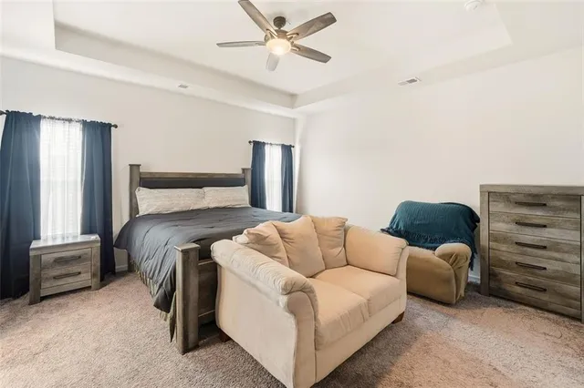 a bedroom with a bed and ceiling fan