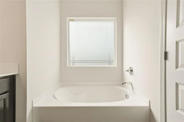 a white bath tub sitting next to a window