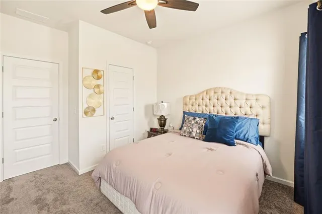 a bedroom with a bed and a painting