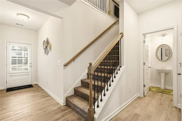 a view of a hallway with entryway wooden floor and front door