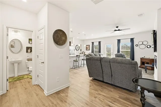 a living room with furniture and a wooden floor