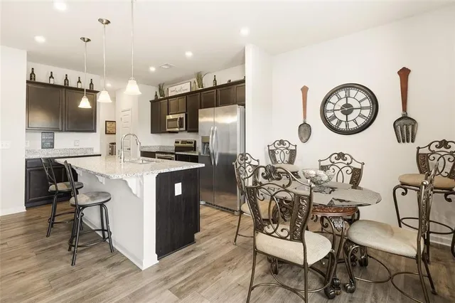 a kitchen with a dining table cabinets and chairs