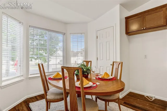 a dining room with furniture and window