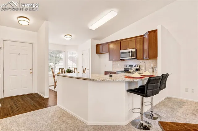 a kitchen with a sink cabinets and wooden floor