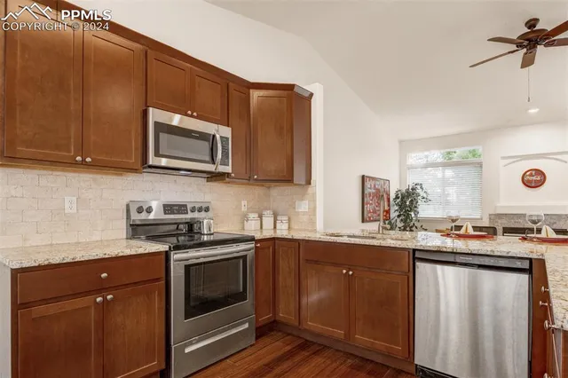 a kitchen with stainless steel appliances a stove sink microwave and cabinets