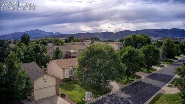 an aerial view of residential houses with outdoor space and green space