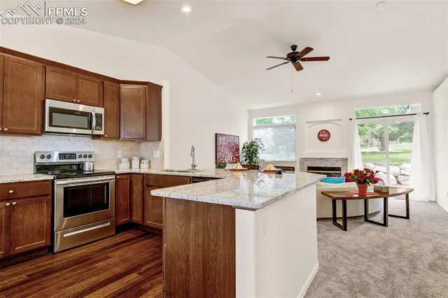 a kitchen with a stove a microwave and wooden cabinets