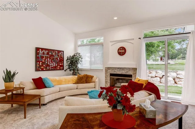 a living room with furniture fireplace and window