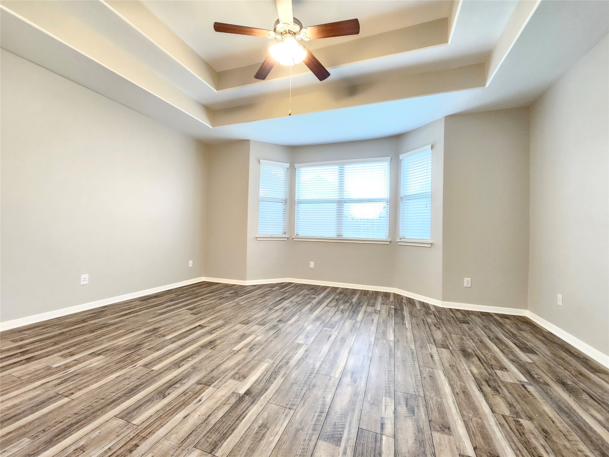 4407 Greenleaf Drive Spring, TX 77389 - Photo 13 of 29 an empty room with wooden floor chandelier fan and windows