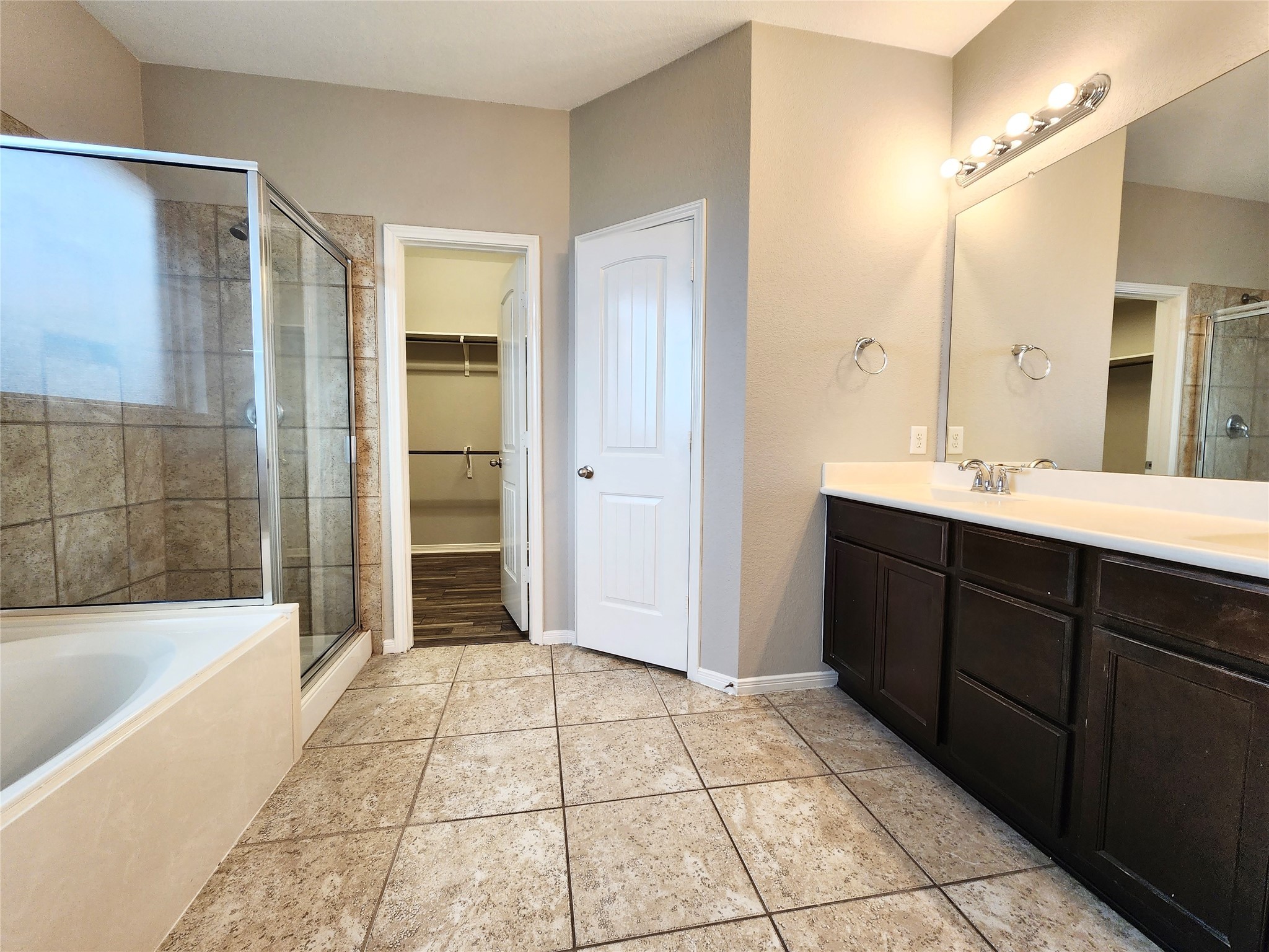 4407 Greenleaf Drive Spring, TX 77389 - Photo 14 of 29 a spacious bathroom with a mirror a shower and a bathtub