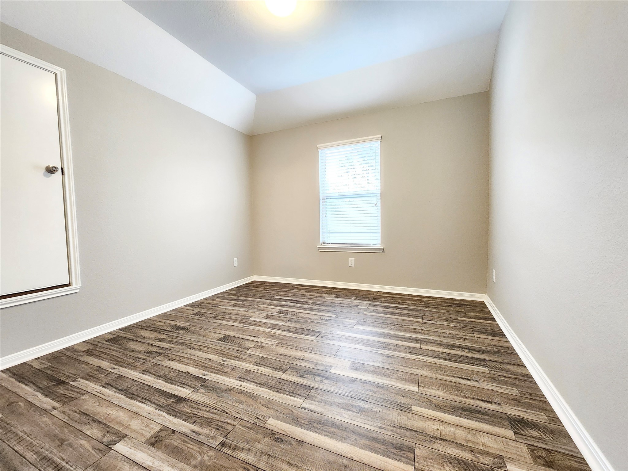4407 Greenleaf Drive Spring, TX 77389 - Photo 22 of 29 an empty room with wooden floor and windows
