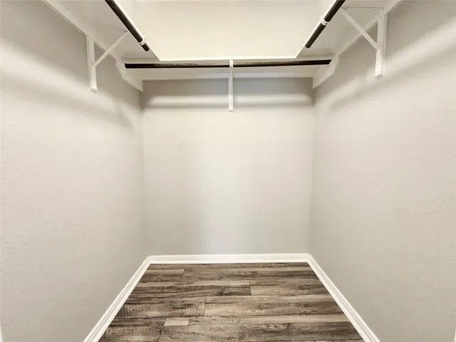 a bathroom with a double vanity sink a toilet a mirror and shower