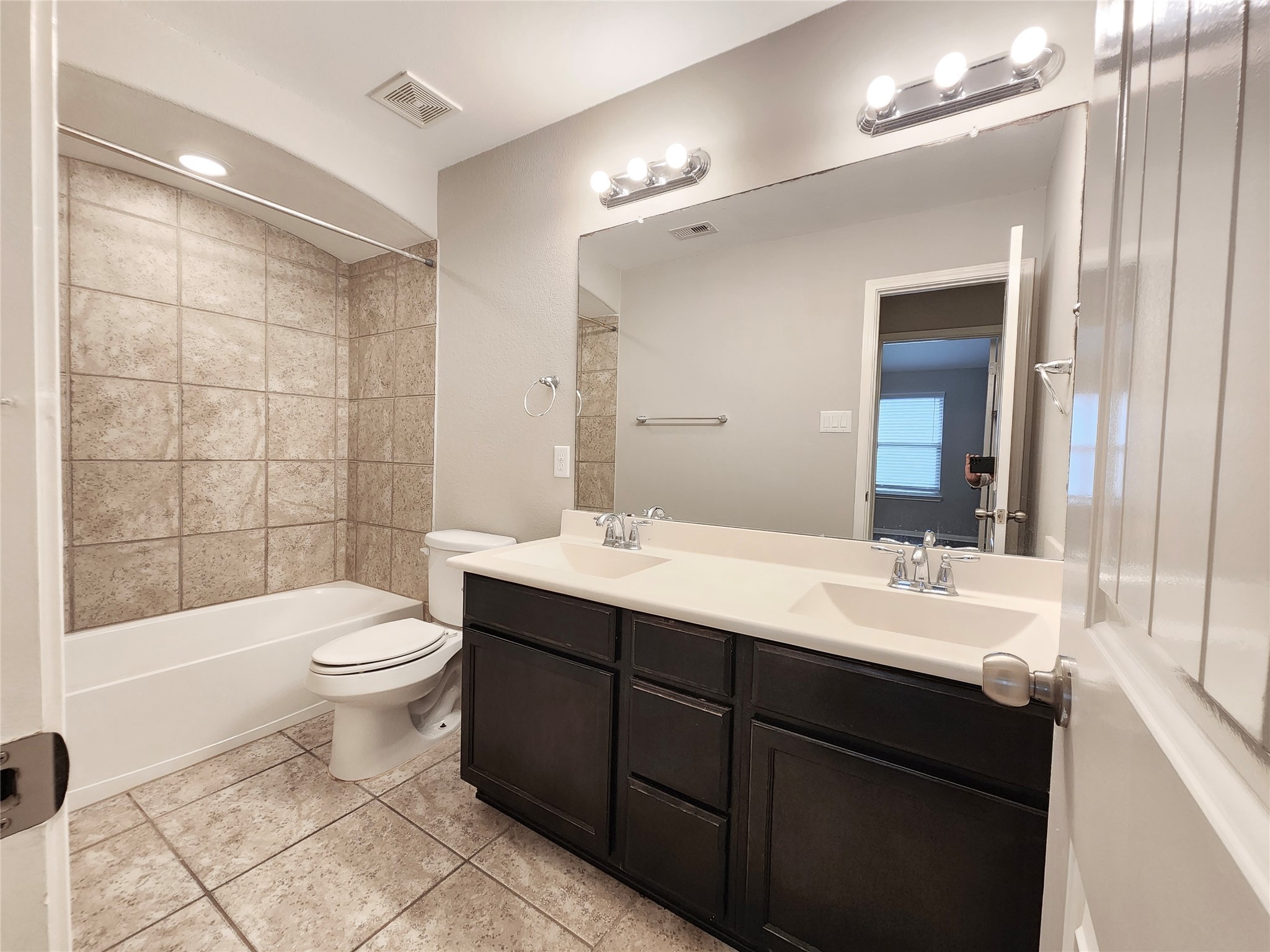 4407 Greenleaf Drive Spring, TX 77389 - Photo 26 of 29 a bathroom with a double vanity sink a toilet a mirror and shower