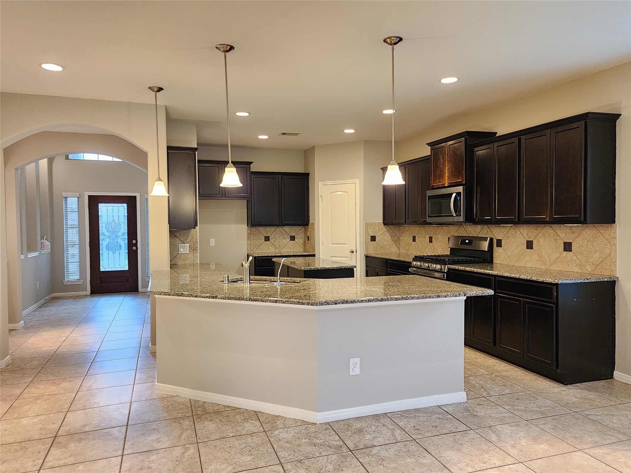 4407 Greenleaf Drive Spring, TX 77389 - Photo 7 of 29 a large kitchen with stainless steel appliances kitchen island granite countertop a large counter top and a view of living room
