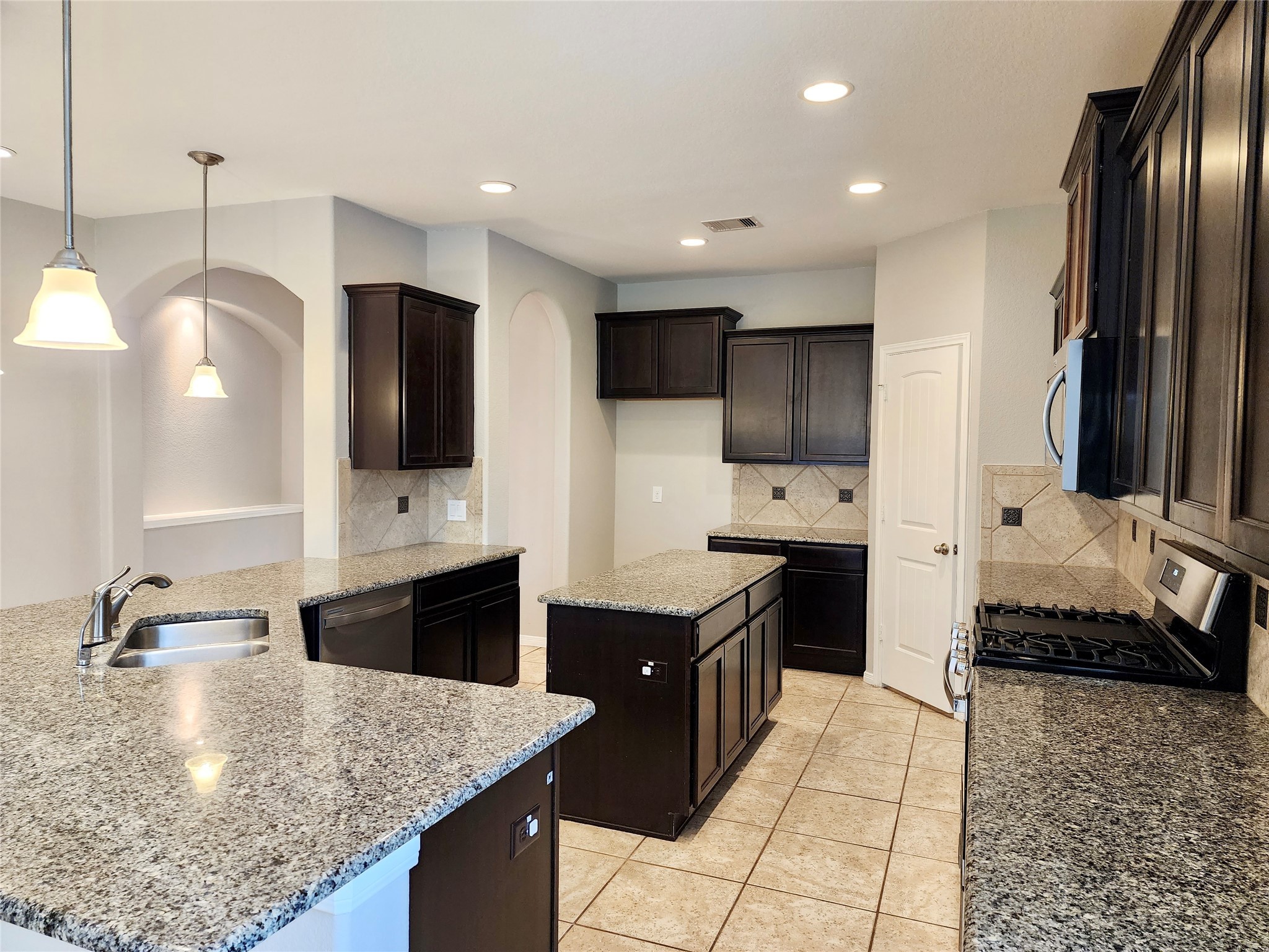4407 Greenleaf Drive Spring, TX 77389 - Photo 9 of 29 a kitchen with stainless steel appliances granite countertop a sink a stove top oven a refrigerator and a oven