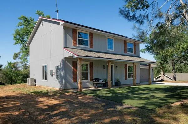 a view of a house with a yard