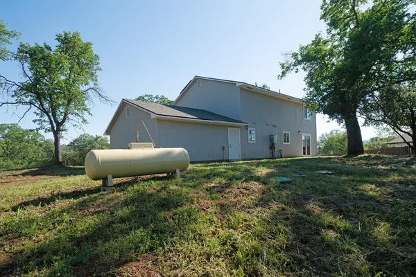 a view of a bedroom with wooden floor and a rug