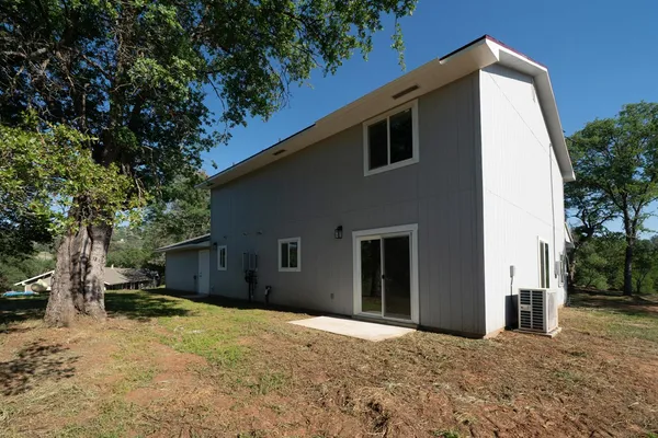a large kitchen with granite countertop a stove top oven a sink dishwasher and a refrigerator with wooden floor