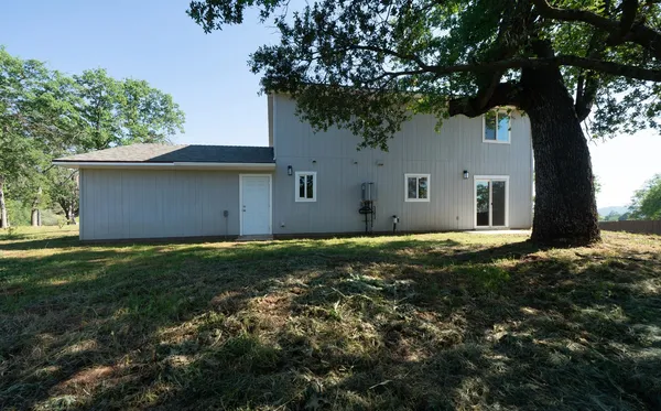 a kitchen with granite countertop white cabinets and a stove