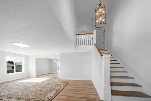 a view of a livingroom with wooden floor and a window