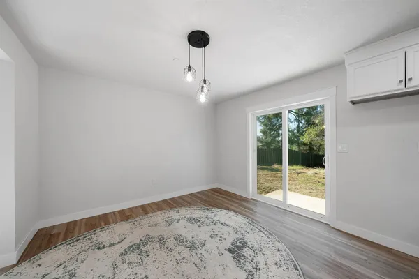 a kitchen with granite countertop a stove a sink and a microwave