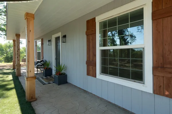 an aerial view of residential houses with outdoor space and trees