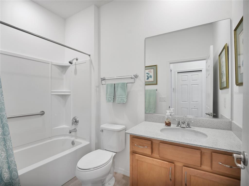 7832 Southwest 86th Loop Ocala, FL 34476 - Photo 11 of 40 a bathroom with a granite countertop sink a toilet and shower