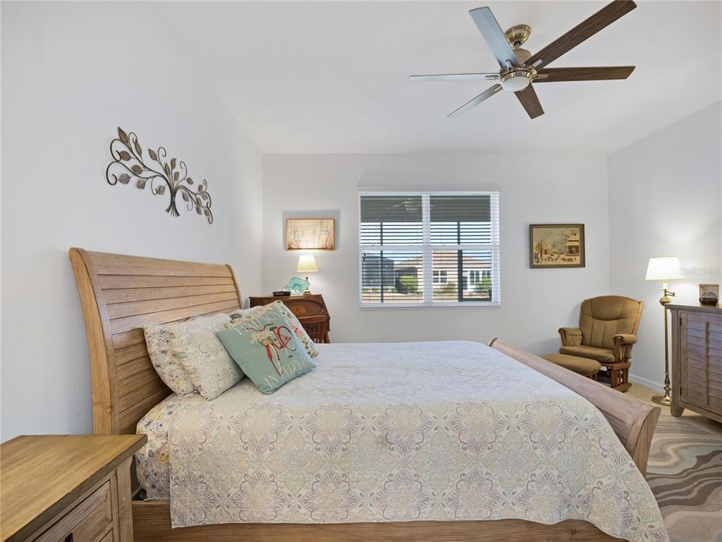 7832 Southwest 86th Loop Ocala, FL 34476 - Photo 27 of 40 a bedroom with a bed flat screen tv and a window