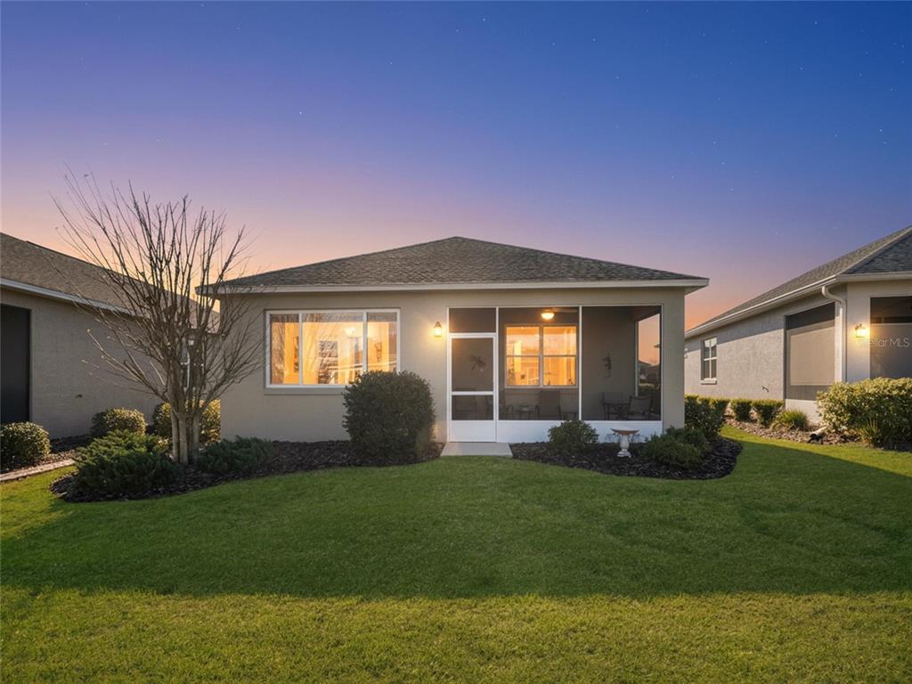 7832 Southwest 86th Loop Ocala, FL 34476 - Photo 4 of 40 a front view of a house with a yard