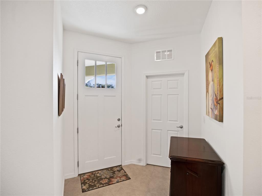 7832 Southwest 86th Loop Ocala, FL 34476 - Photo 5 of 40 a room that has a bed and a window in it