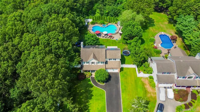 an aerial view of a house with a swimming pool