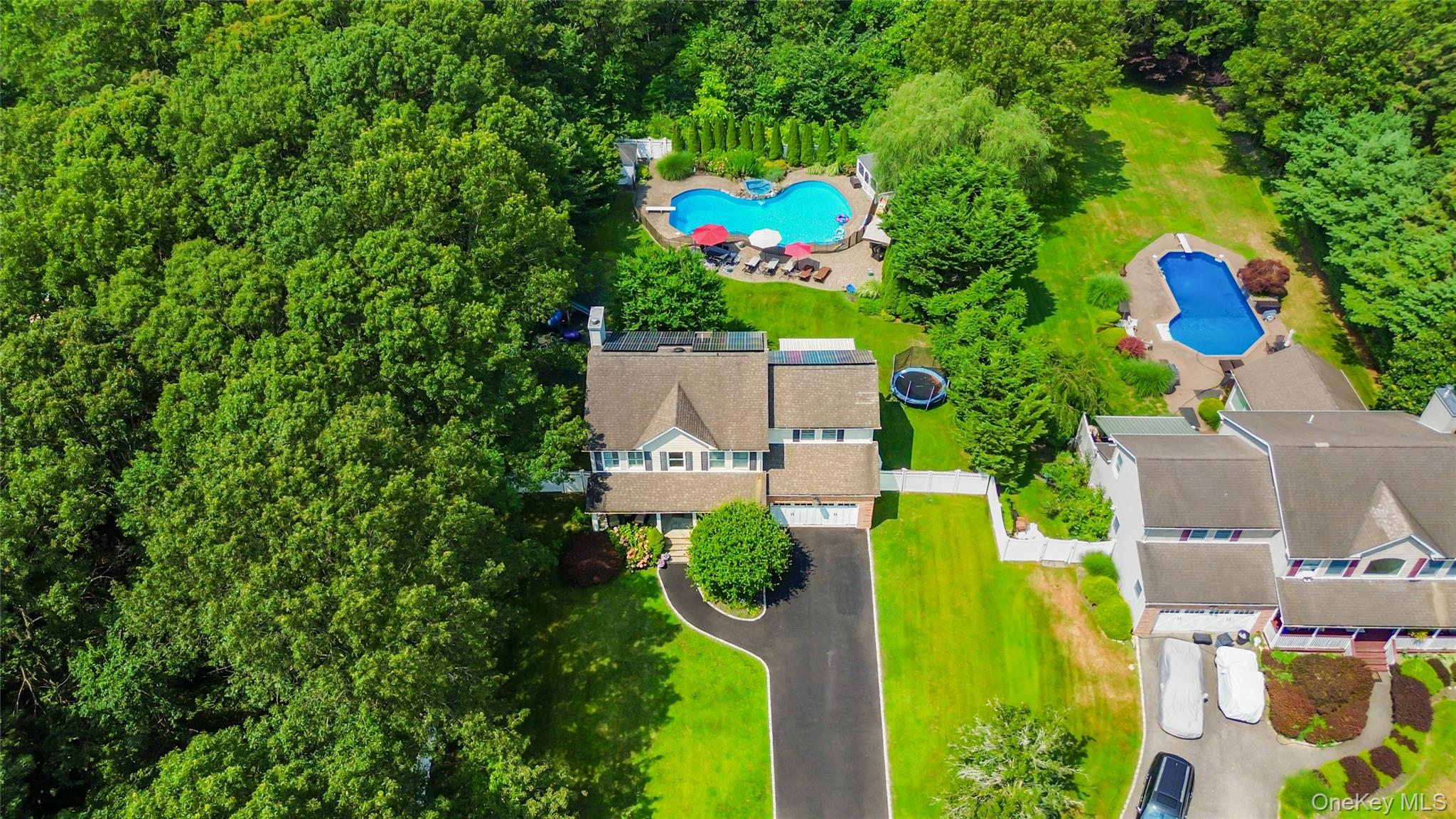 an aerial view of a house with a swimming pool