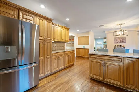 a kitchen with stainless steel appliances a refrigerator sink and cabinets