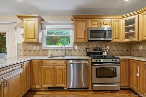 a kitchen with a stove a sink and a microwave