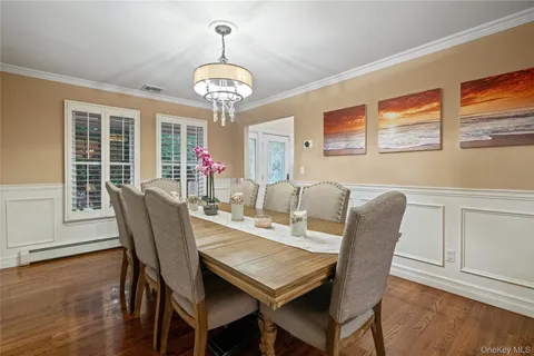 a view of a dining room with furniture wooden floor and chandelier