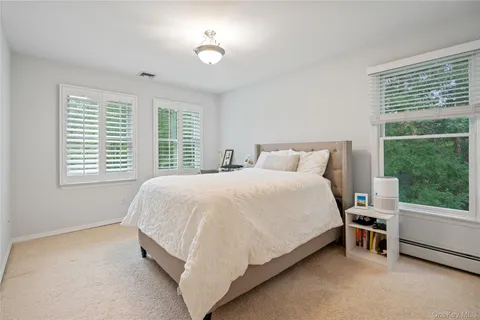 a large bed sitting in a bedroom next to a window
