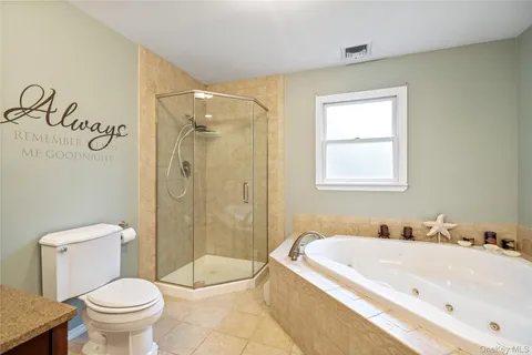 a bathroom with a granite countertop toilet a sink and a bathtub