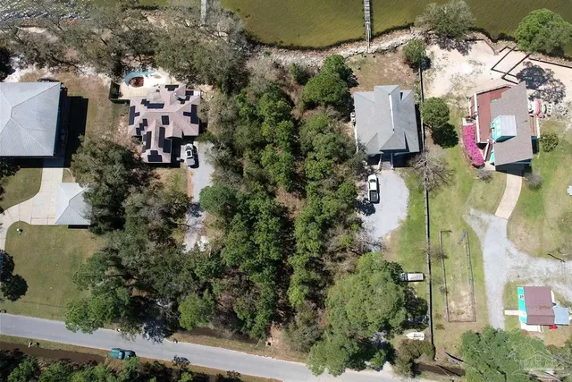 an aerial view of a house with a yard and parking spaces