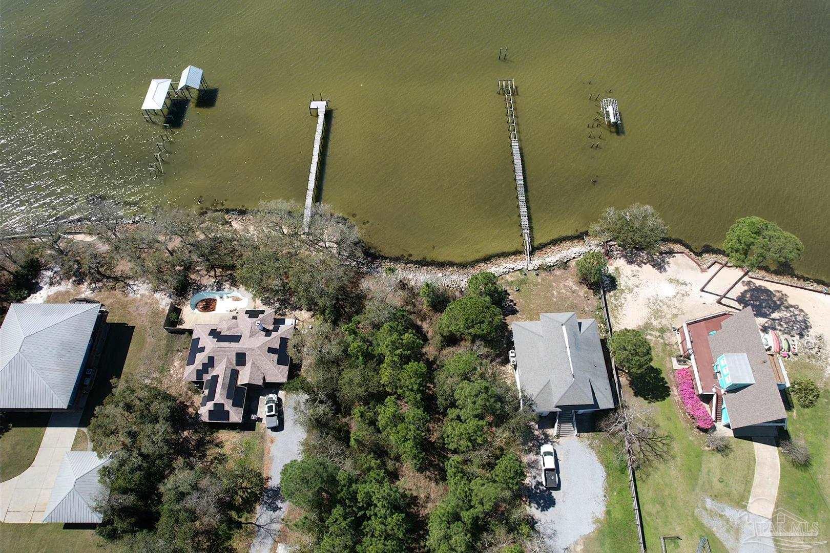 879 Dolphin Road Milton, FL 32583 - Photo 4 of 4 a front view of a house with a yard